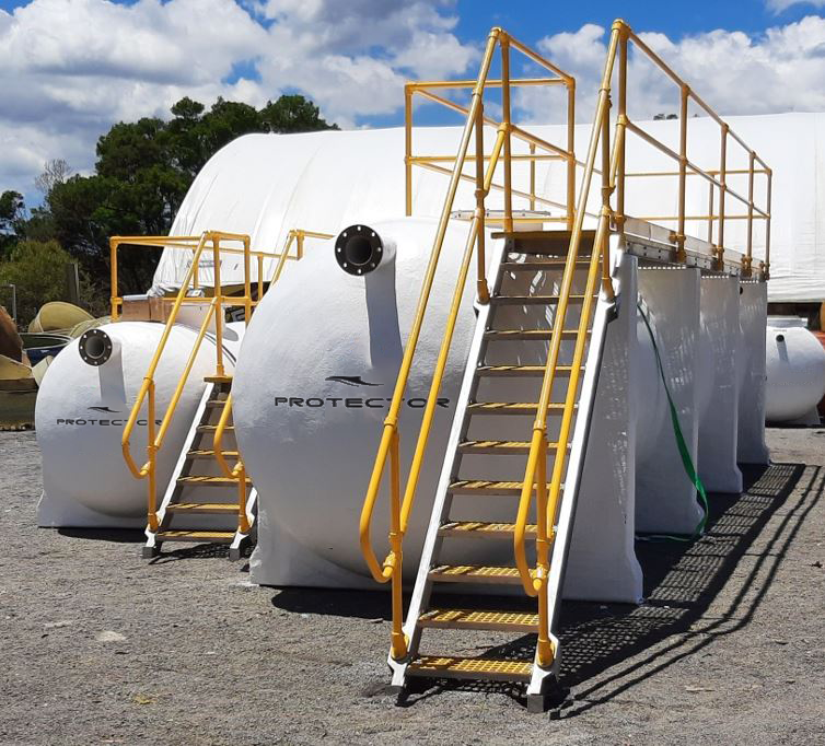 Protector HydroProtector stormwater treatment systems with integrated access platforms and safety handrails at the manufacturing facility.